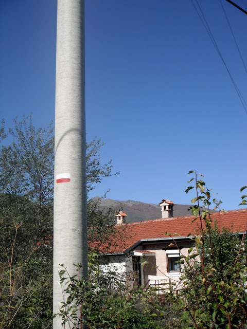 trailmarkers on telephone poles for the St. Spas cave church hike in Vishni, Macedonia 